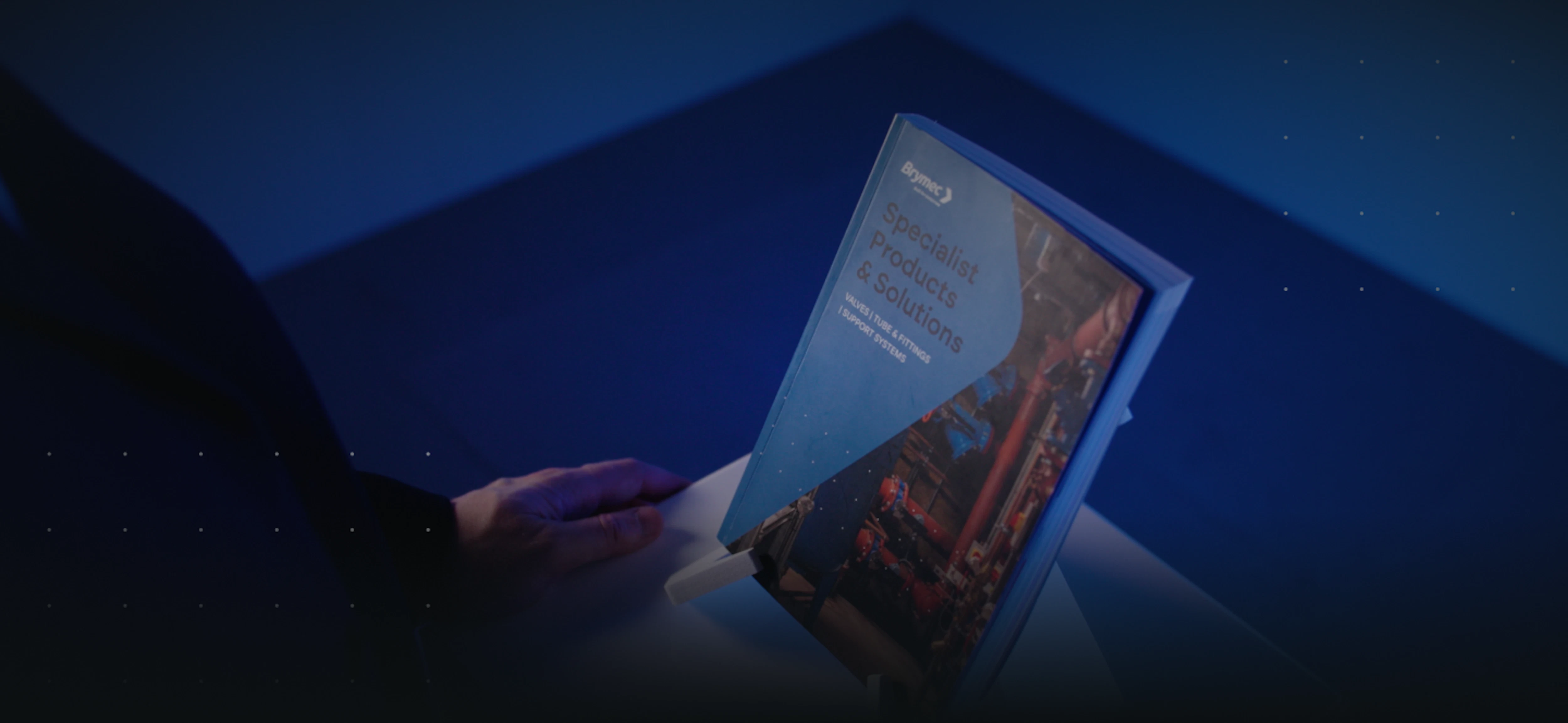 brymec catalogue on stand with hands reaching for it