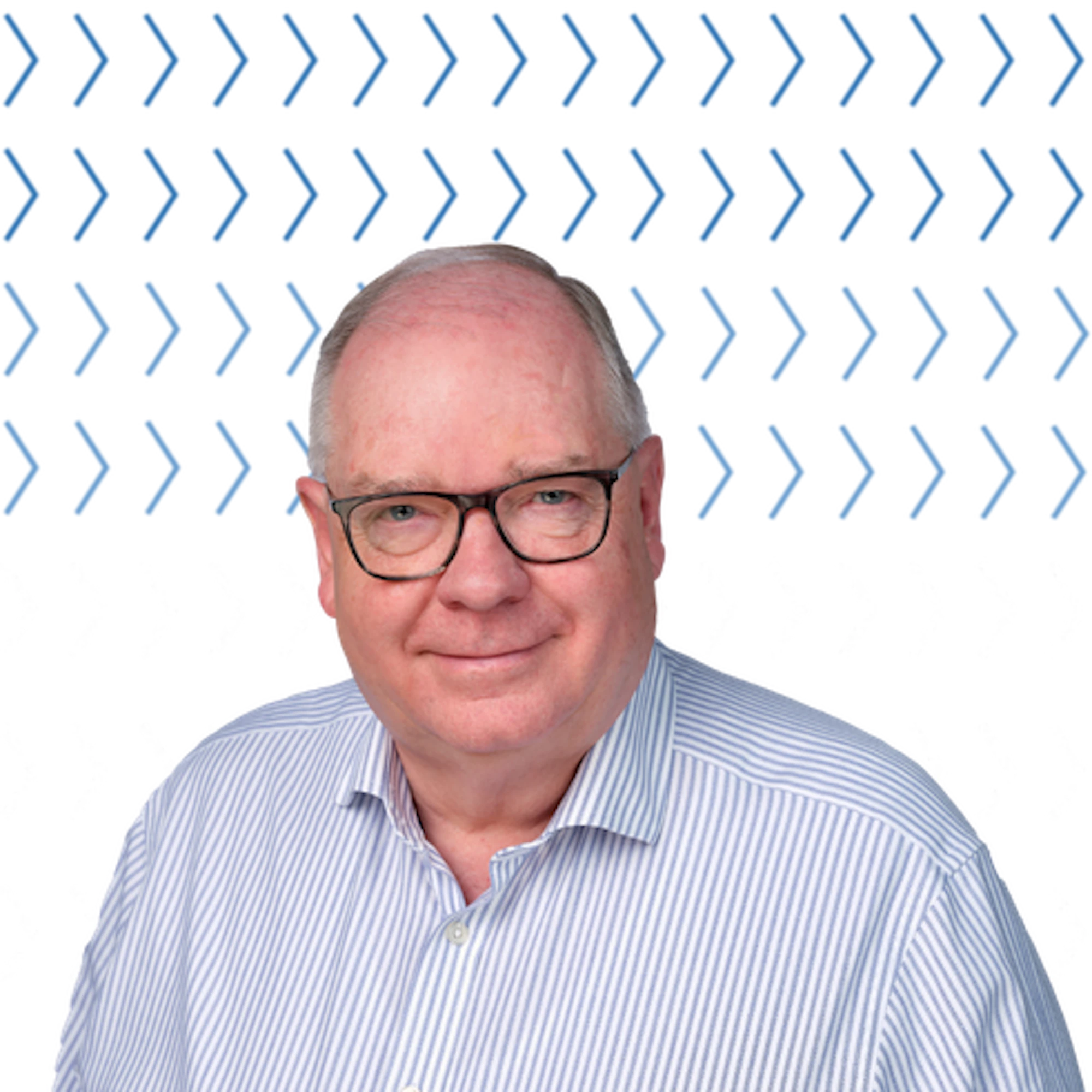 graham reiner wearing glasses and blue and white striped shirt.